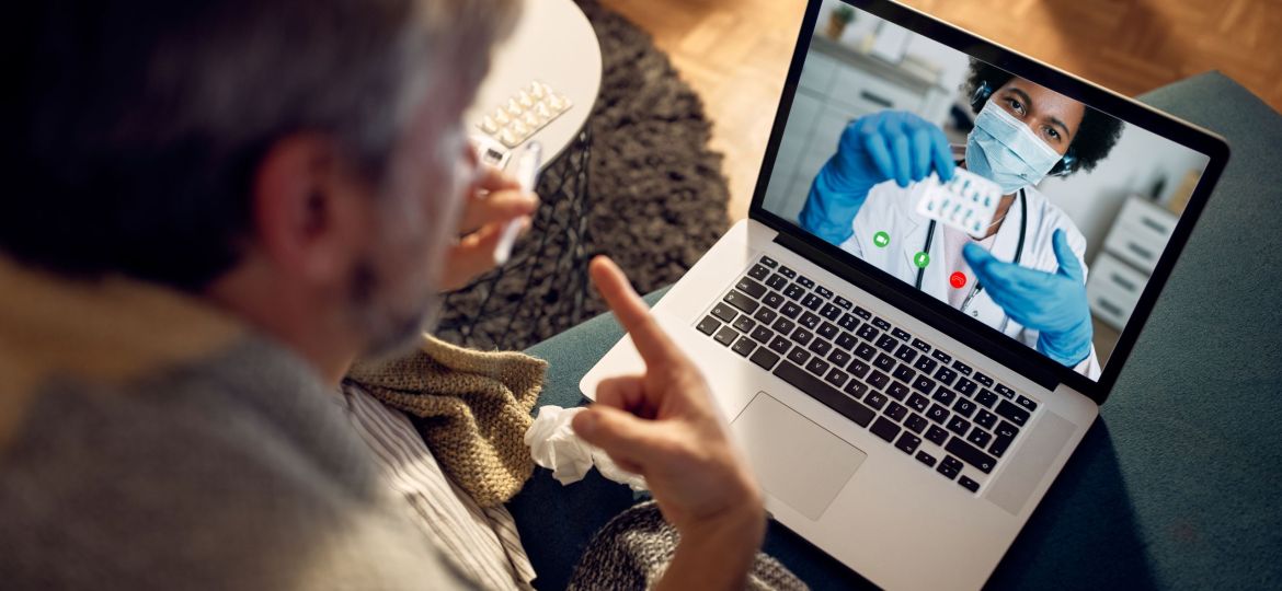 Close-up of man having video call with his doctor in the evening