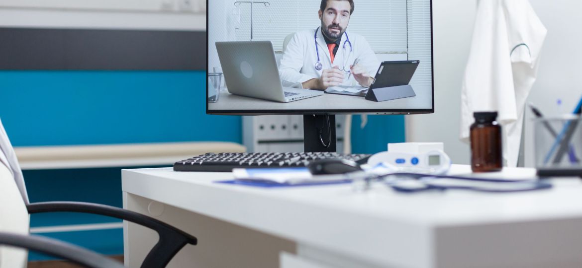 Computer screen with remote doctor having online videocall meeting