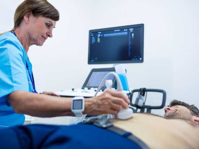 Man getting ultrasound of a abdomen from doctor