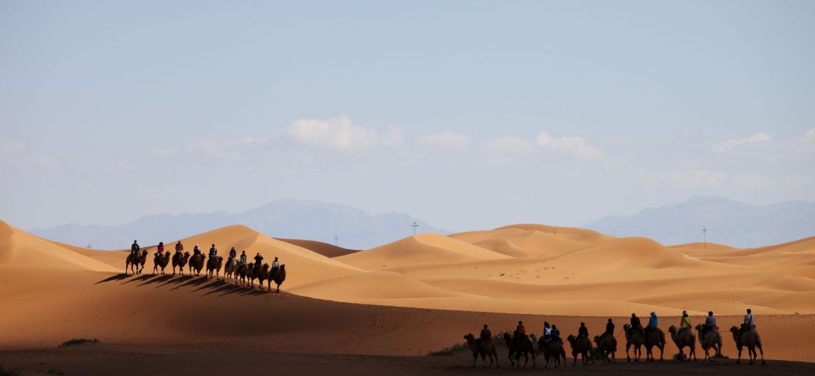 Camel caravan in a desert in Xinjiang, China