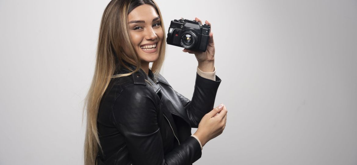 Girl in leather jacket taking her photos in elegant and positive positions